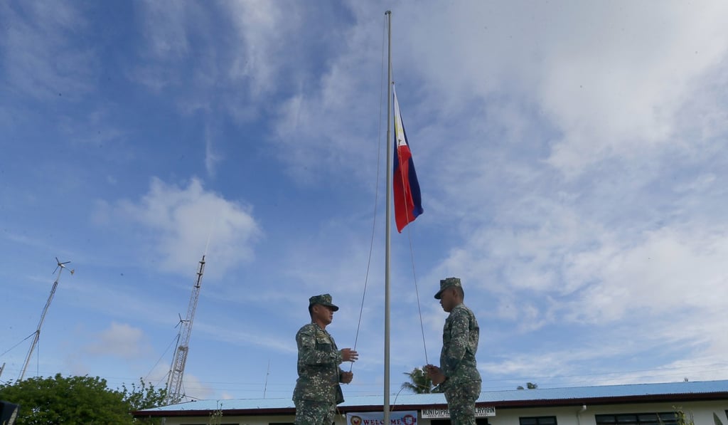 Soldiers raise the Philippine flag during a ceremony upon the arrival of Philippine Defence Secretray Delfin Lorenzana, Armed Forces Chief General Eduardo Ano and other officials on the Philippine-claimed island of Pag-asa, in the disputed Spratly islands. Photo: AP Soldiers raise the Philippine flag during a ceremony upon the arrival of Philippine Defence Secretray Delfin Lorenzana, Armed Forces Chief General Eduardo Ano and other officials on the Philippine-claimed island of Pag-asa, in the disputed Spratly islands. Photo: AP