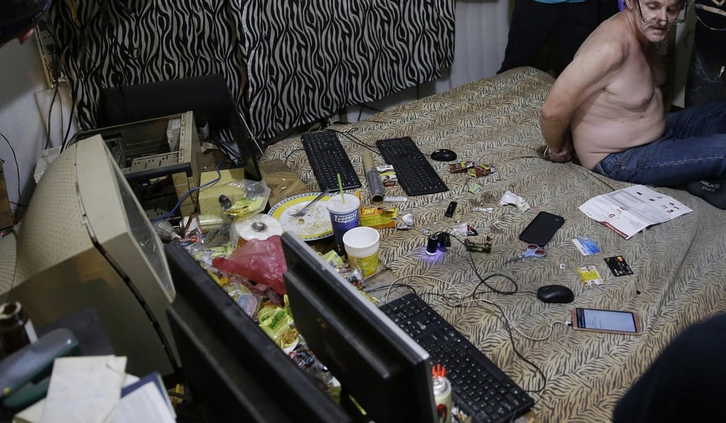 Suspected child webcam cybersex operator David Timothy Deakin during a raid on his home in Mabalacat, Philippines. Photo: AP