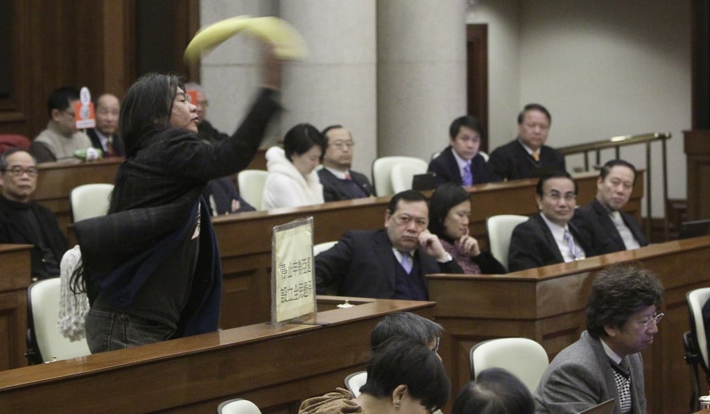 “Long Hair” Leung Kwok-hung hurls a banana during a Legco meeting in 2011. Picture: Sam Tsang