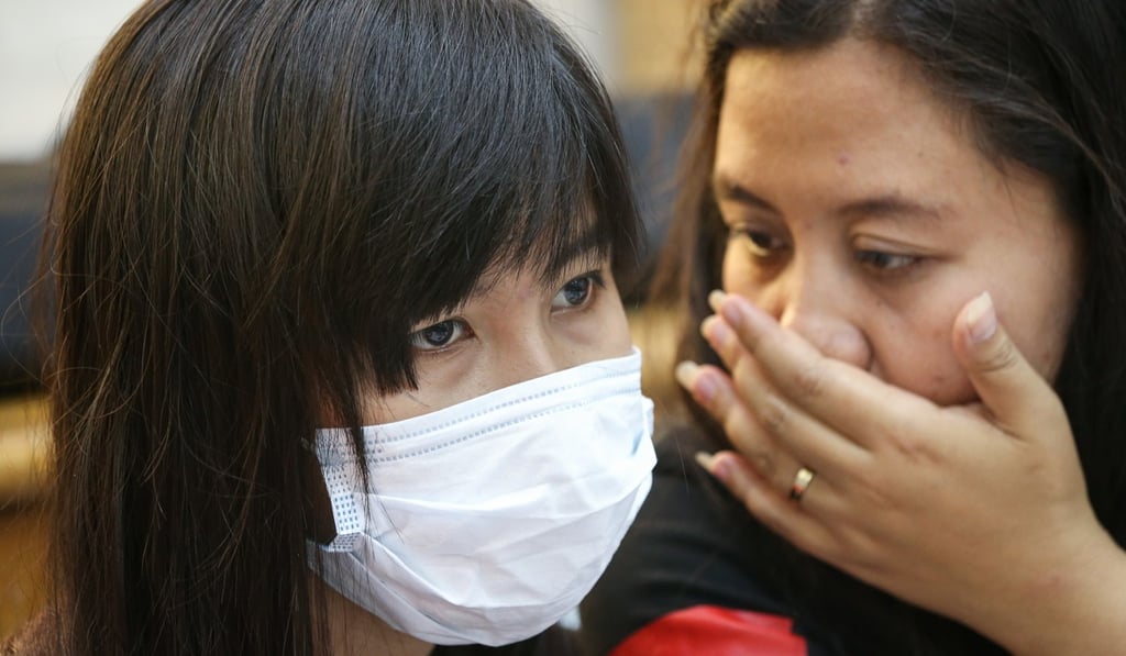 Two women attend a press conference as the Federation of Asian Domestic Workers Unions reveals how intermediaries and their subsidiaries abuse and overcharge domestic workers. Photo: Dickson Lee