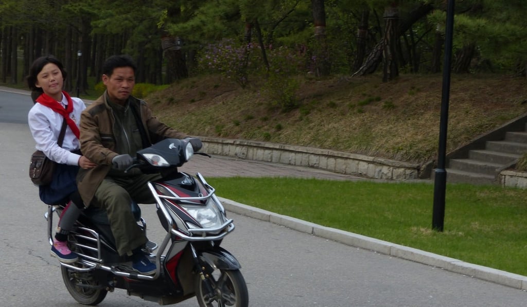 North Koreans on an electric bike in Pyongyang. Photo: Liu Zhen