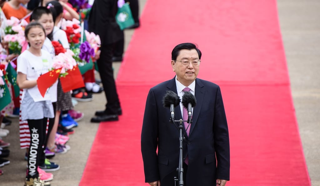 National People’s Congress Standing Committee chairman Zhang Dejiang speaks to the press shortly after his arrival at the international airport in Macau last Monday. Photo: AFP National People’s Congress Standing Committee chairman Zhang Dejiang speaks to the press shortly after his arrival at the international airport in Macau last Monday. Photo: AFP