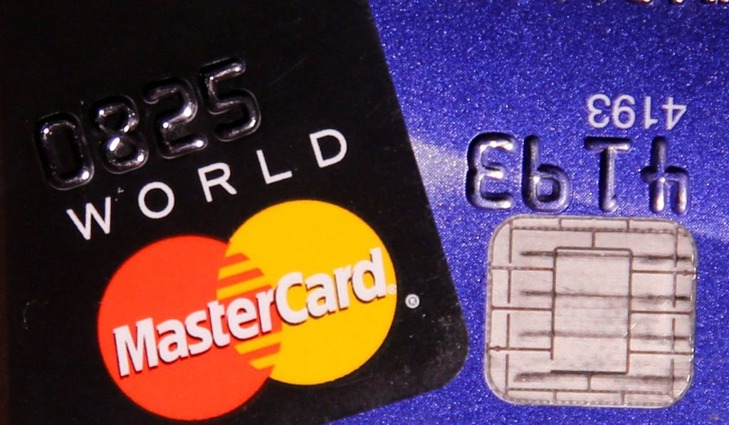 A MasterCard credit card is pictured next to a computer chip on a bank card. Photo: Reuters