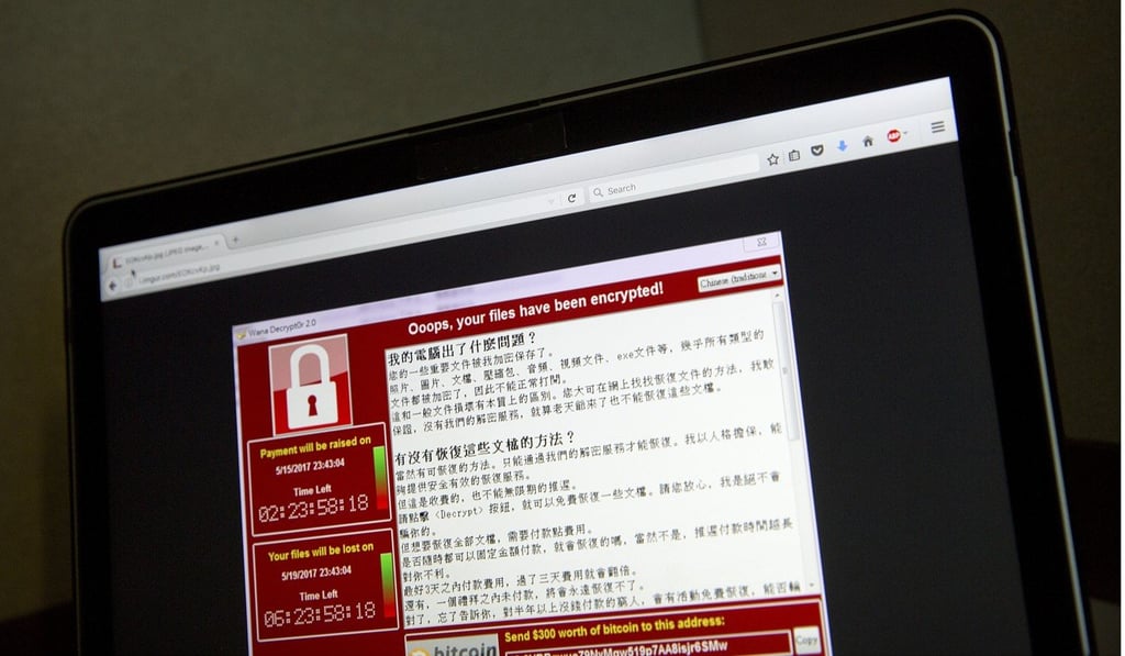 A screenshot of the warning screen from a purported ransomware attack, as captured by a computer user in Taiwan, is seen on laptop in Beijing. Photo: AP