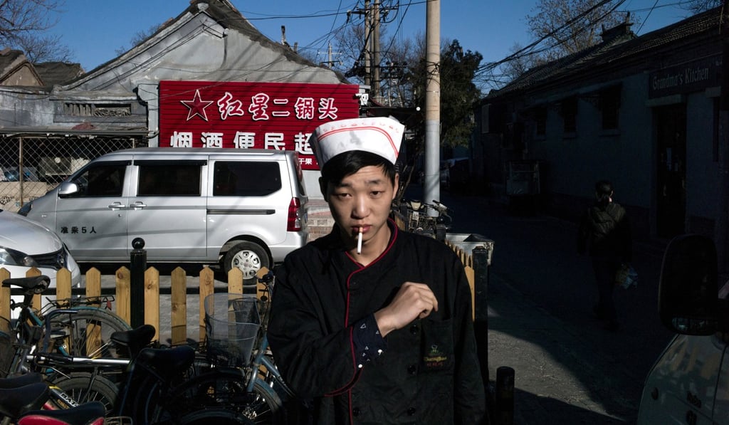 A cook takes a cigarette break in Beijing. Photo: AFP