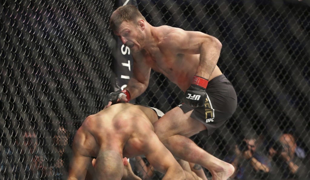 Stipe Miocic (top) moves in to finish Junior dos Santos. Photo: AP