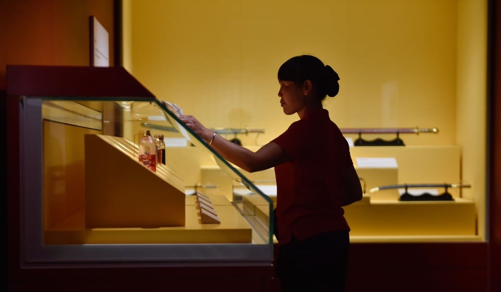 A worker cleans a showcase at the new facility. Photo: Xinhua