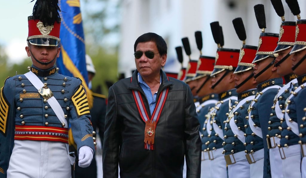 President Rodrigo Duterte reviews an honour guard. Photo: EPA