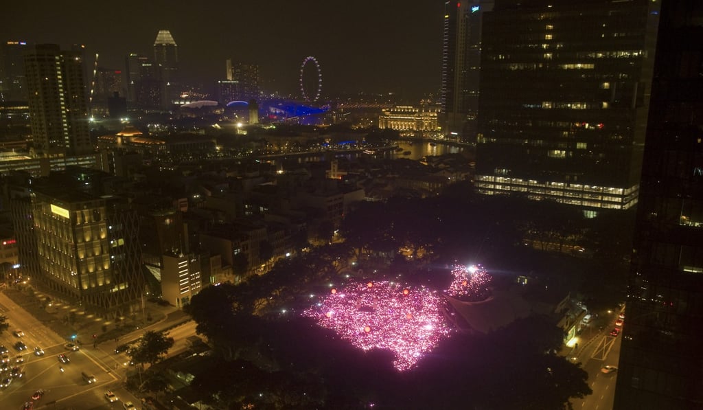People with LED lights take part in forming a giant pink dot during a Pink Dot rally in Singapore in 2013. Photo: Xinhua