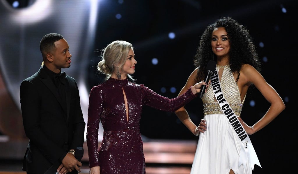 Co-hosts Terrence J and Julianne Hough look on as Miss District of Columbia USA 2016 Kara McCullough answers a question during the interview portion of the 2017 Miss USA pageant. Photo: AFP
