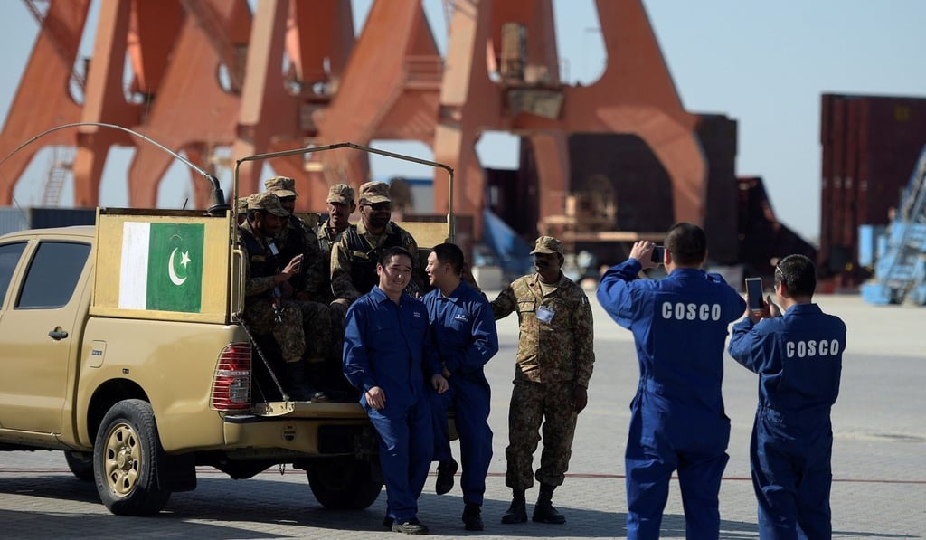 Chinese workers pose for a picture with Pakistani soldiers at Gwadar port. Photo: AFP