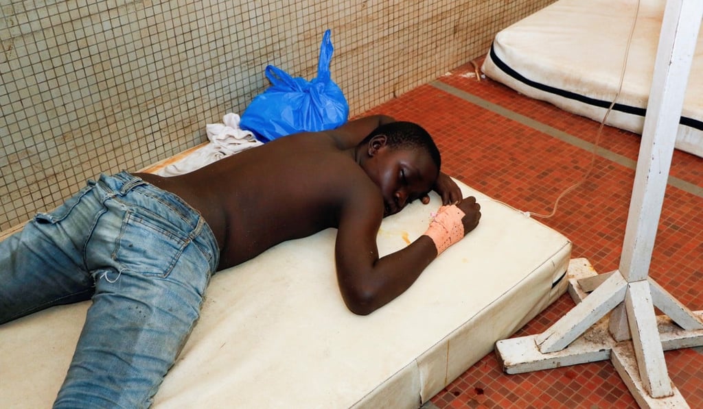 An unidentified young demonstrator lies in hospital after being injured during a rally against a military mutiny in Bouake, Ivory Coast, on Sunday. Photo: Reuters