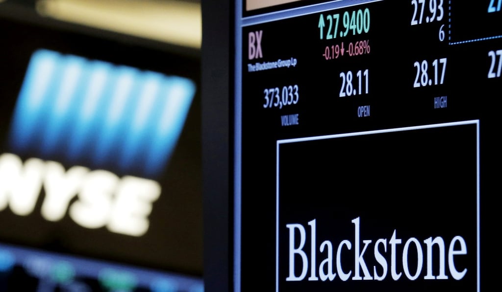 The ticker and trading information for Blackstone Group is displayed at the post where it is traded on the floor of the New York Stock Exchange (NYSE). The company is asking Standard Chartered to buy back a stake in a Singapore firm it sold off a year ago. Photo: Reuters