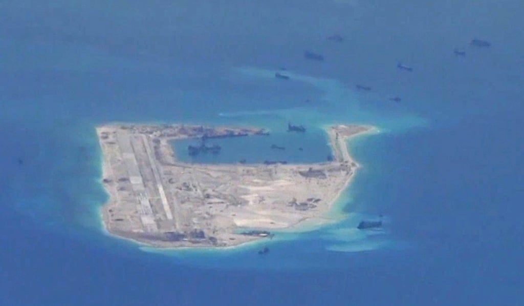 Chinese dredging vessels are purportedly seen in the waters around Fiery Cross Reef in the disputed Spratly Islands in a file photo from May 2015. Photo: Reuters