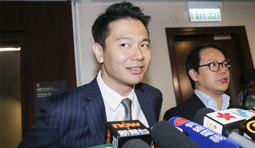 Accompanied by fellow DAB party member Gary Chan Hak-kan (R), lawmaker Holden Chow Ho-ding meets the media at the Legislative Council in Tamar. Chow apologised for