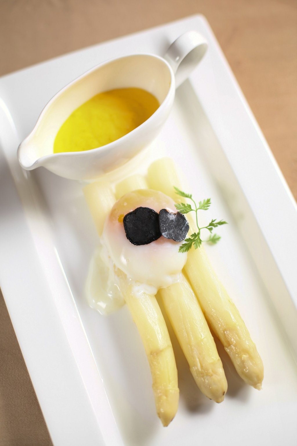 Soft-boiled organic egg with sautéed white asparagus and sage, and parmesan cheese fondue with black truffle.