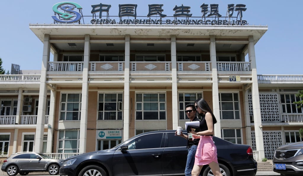 People walk past a branch of China Minsheng Bank in Beijing, as net forex sales by Chinese banks hit a three-month high in April 2017. Photo: Reuters