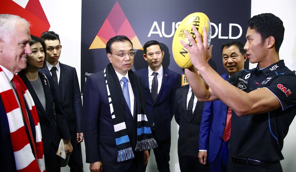 Turnbull and China's Premier Li Keqiang with Port Adelaide Australian Rules footballer Chen Shaoliang. Australia has growing roots and trade in Asia. Photo: AFP