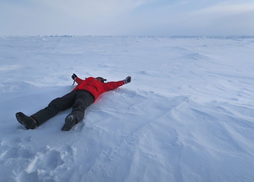 A triumphant member of the travel group on top of the world at the North Pole. Photo: Pavel Toropov