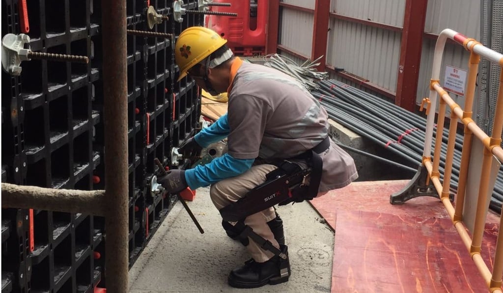 A construction worker equipped with a modular agile exoskeleton suit.