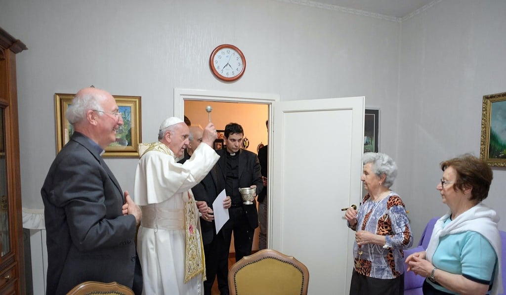 Pope Francis blesses a house during his visit to Ostia, in the outskirts of Rome. Photo: Osservatore Romano handout via Reuters