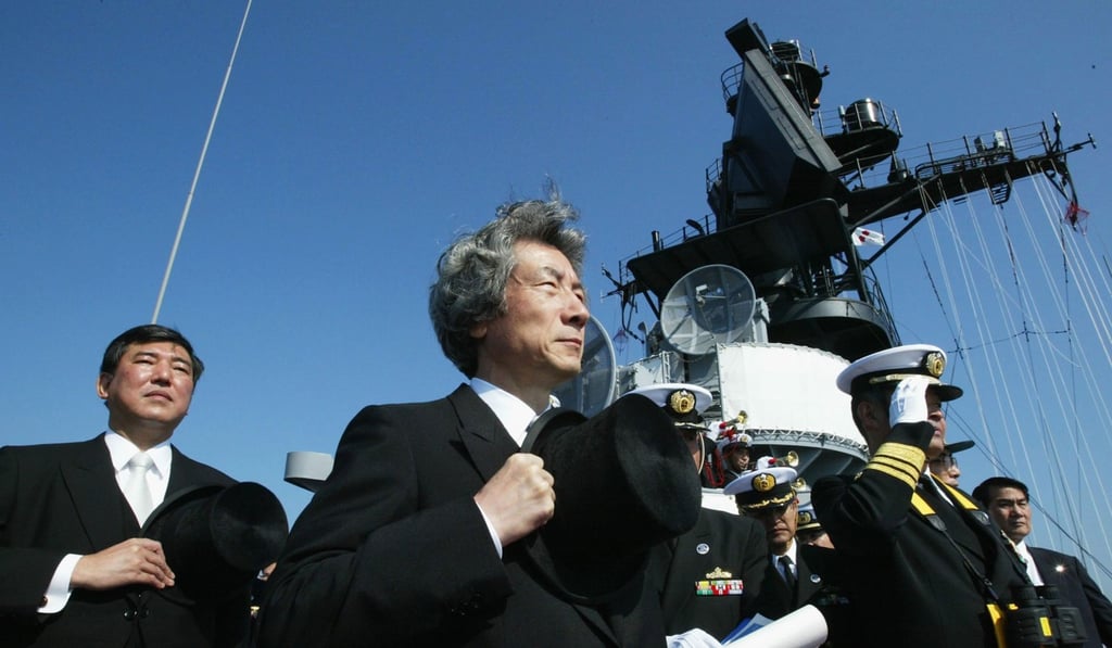 Junichiro Koizumi, then Japan’s prime minister in 2013, and Defence Minister Shigeru Ishiba salute the Japanese Maritime Self-Defence Force during a naval review. File Photo: AFP