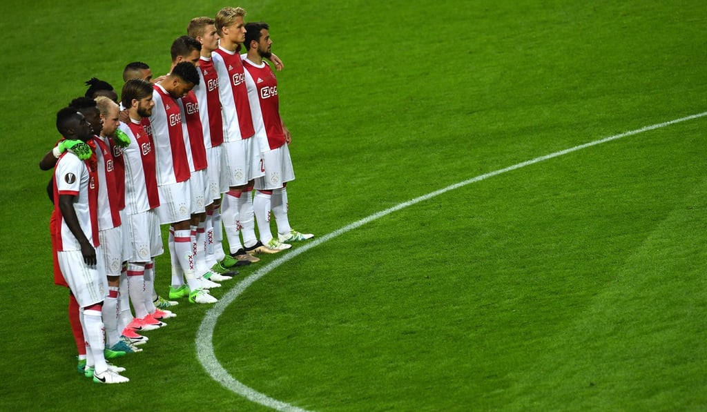 Ajax players hold a minute of silence to pay tribute to the victims of the Manchester terror attack. EPA/VASSIL DONEV Ajax players hold a minute of silence to pay tribute to the victims of the Manchester terror attack. EPA/VASSIL DONEV