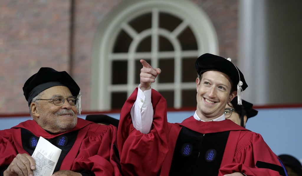 Facebook CEO and Harvard dropout Mark Zuckerberg, right, gestures as actor James Earl Jones, left, looks on while seated on stage during Harvard University commencement exercises on May 25, 2017. UK Prime Minister Theresa May wants Facebook and other internet companies to do more to combat terror. Photo: AP