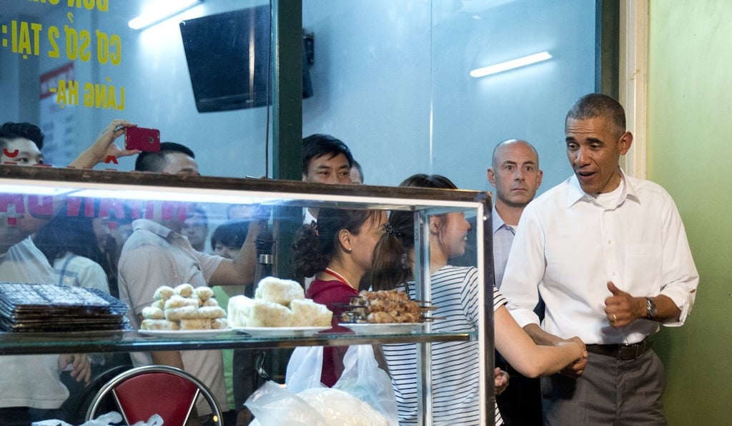 President Barack Obama greets women at the door as he walks from a restaurant after having dinner with American Chef Anthony Bourdain in Hanoi, Vietnam. Photo: AP
