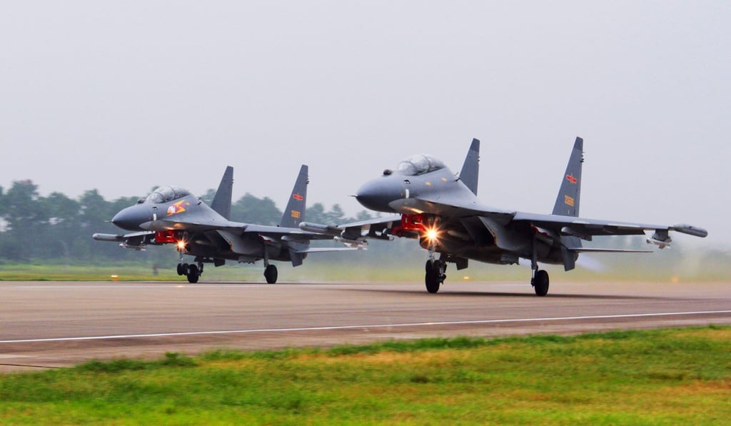 Two Chinese SU-30 fighter jets take off for a patrol over the South China Sea. Photo: Xinhua
