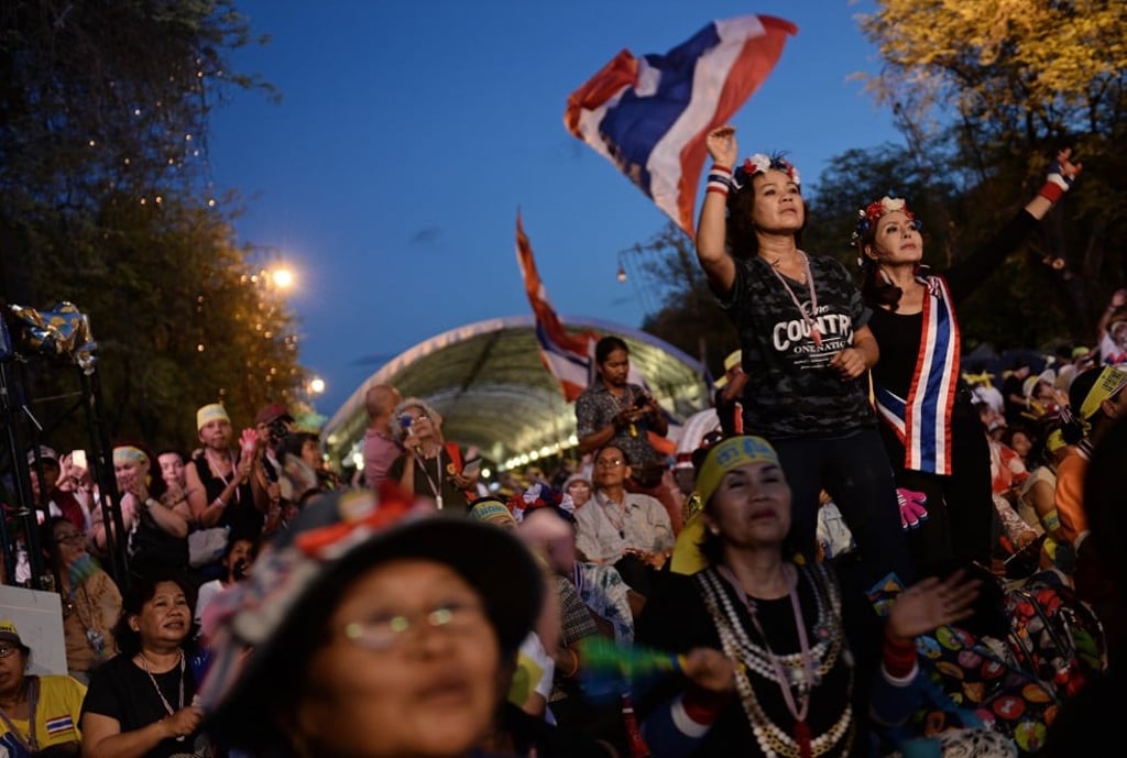 Anti-government protesters celebrate outside Government House, in Bangkok, after Thailand’s army chief announced that the armed forces were seizing power, on May 22, 2014. Picture: AFP