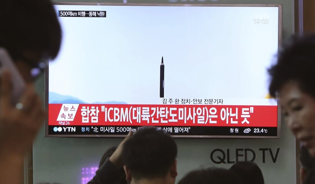 People watch a TV news programme showing a file image of a missile launch conducted by North Korea, at the Seoul Railway Station in Seoul, South Korea. The US is testing a system to intercept ICBM missiles next week. Photo: AP