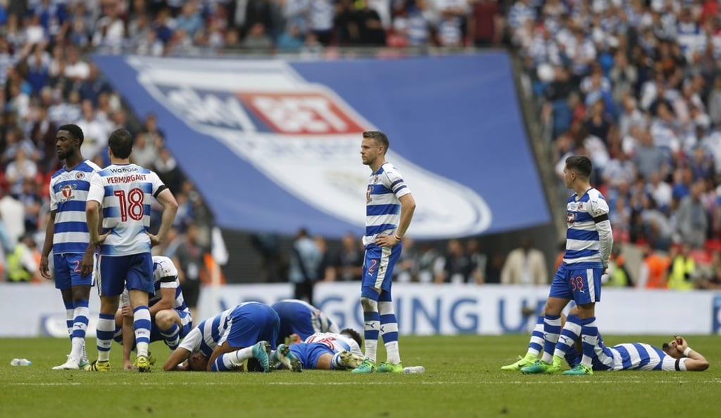 Reading players look dejected after losing the penalty shoot-out. Photo: Reuters