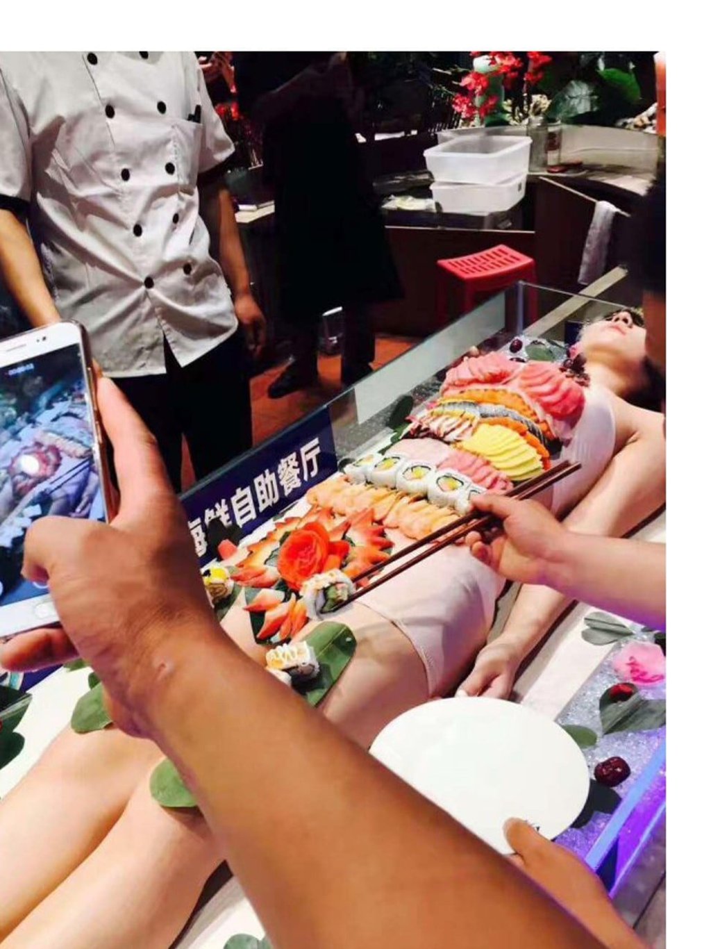 The woman seen with sushi displayed on her body. Photo: Handout