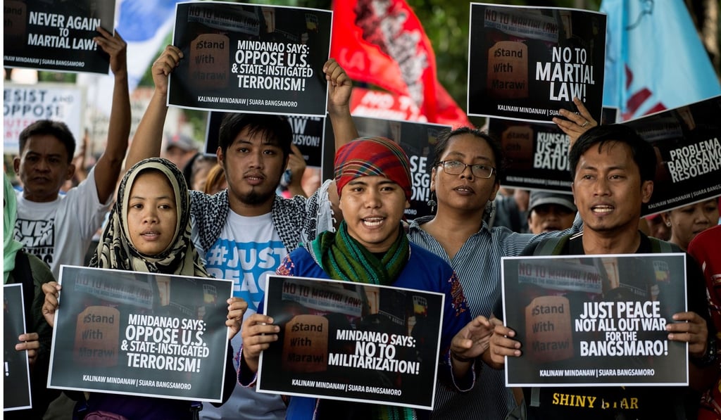 Activists hold up posters as they protest against the imposition of martial law in Mindanao, in front of the Armed Forces of the Philippines headquarters in Manila on May 29. Photo: AFP
