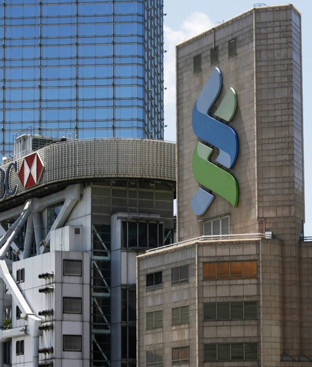 Standard Chartered HQ (left) in Hong Kong. Last Friday it announced it would raise rates on its Hibor-linked mortgages by 10 basis points to 1.4pc above the benchmark rate, effective Monday. Photo: Reuters