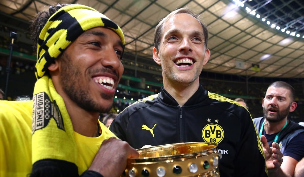 Borussia Dortmund coach Thomas Tuchel celebrates with the trophy and Pierre-Emerick Aubameyang after their cup final victory. Photo: Reuters