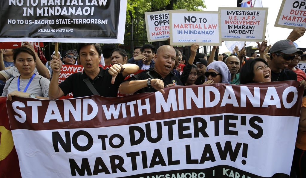 Filipino activists hold slogans opposing the recent declaration of martial law in Mindanao during a rally outside the House of Representatives in Quezon city, metropolitan Manila, Philippines on Wednesday May 31, 2017. Philippine President Rodrigo Duterte declared martial law in the south through mid-July, but lawmakers had asked for a public session of Congress to determine whether it is still necessary. Photo: AP Filipino activists hold slogans opposing the recent declaration of martial law in Mindanao during a rally outside the House of Representatives in Quezon city, metropolitan Manila, Philippines on Wednesday May 31, 2017. Philippine President Rodrigo Duterte declared martial law in the south through mid-July, but lawmakers had asked for a public session of Congress to determine whether it is still necessary. Photo: AP