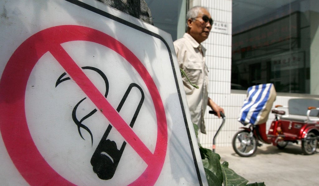 A man walks past a no smoking sign posted in front of a traditional Chinese medicine hospital in Beijing. Photo: AFP