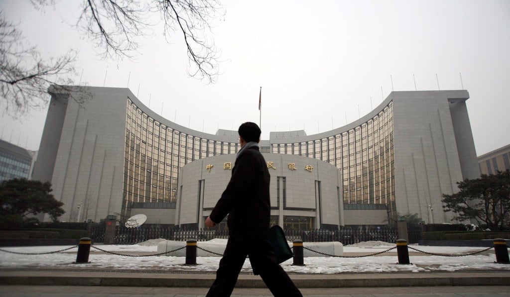 A man walks past the headquarters of the central bank of the People's Republic of China in Beijing. Photo: Reuters