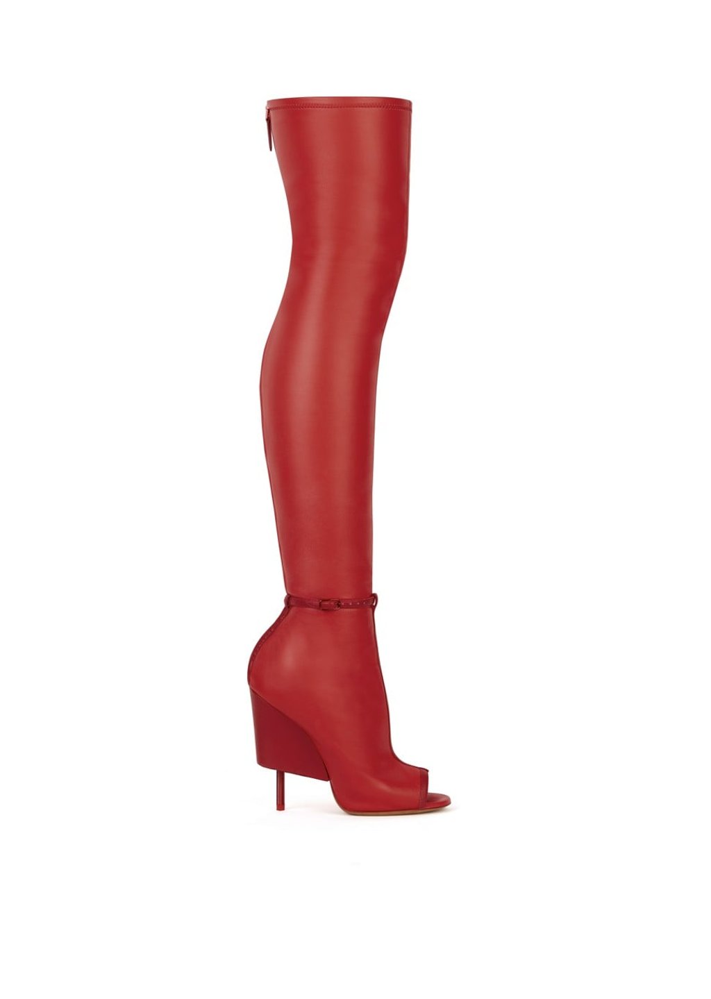 The pseudo wedge on the heel of the over-the-knee boot is an eccentric detail on top of the vivid red palette. Price on request
