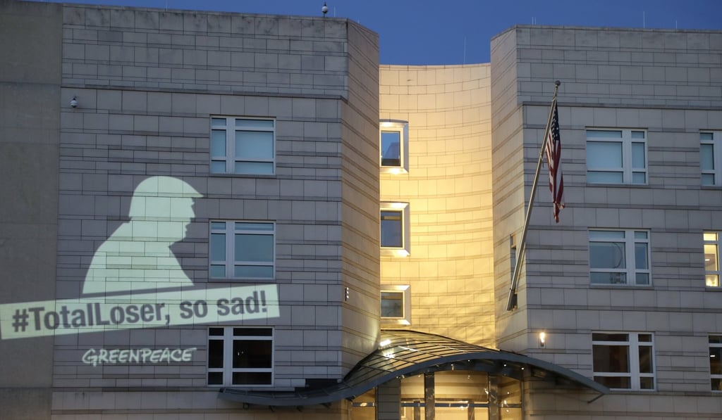 A Greenpeace banner showing US President Donald Trump and the slogan '#TotalLoser, so sad!' projected on the facade of the US Embassy in Berlin, Germany, on Friday. Photo: AP