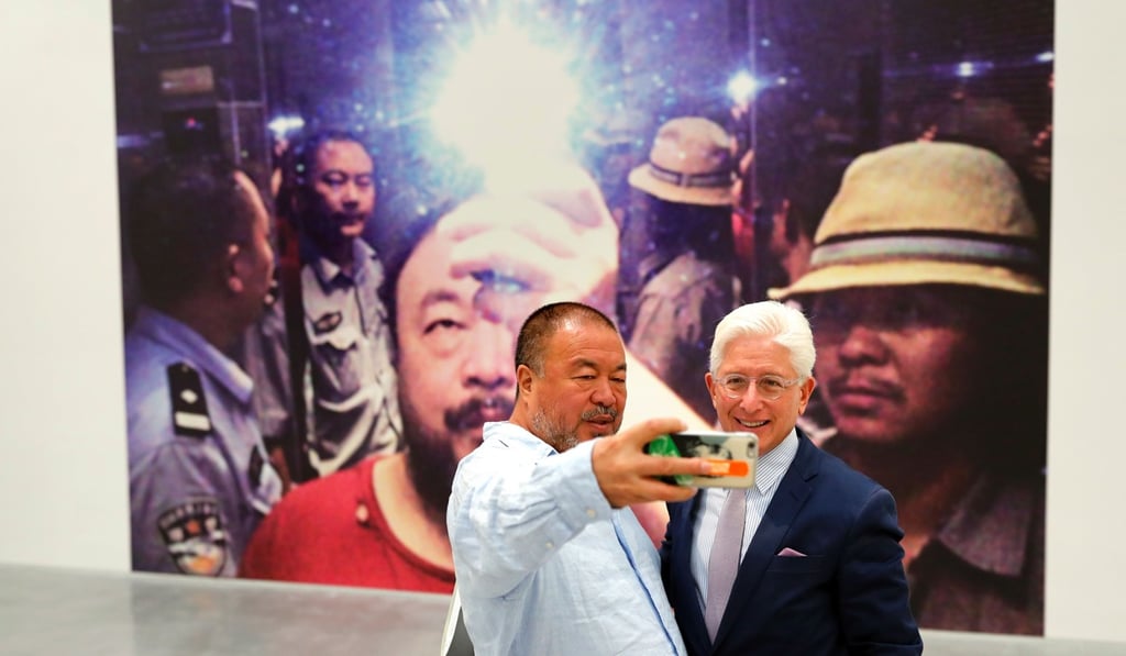 Chinese artist Ai Weiwei takes a selfie with Israel Museum director James Snyder in front of his art work Chinese artist Ai Weiwei takes a selfie with Israel Museum director James Snyder in front of his art work