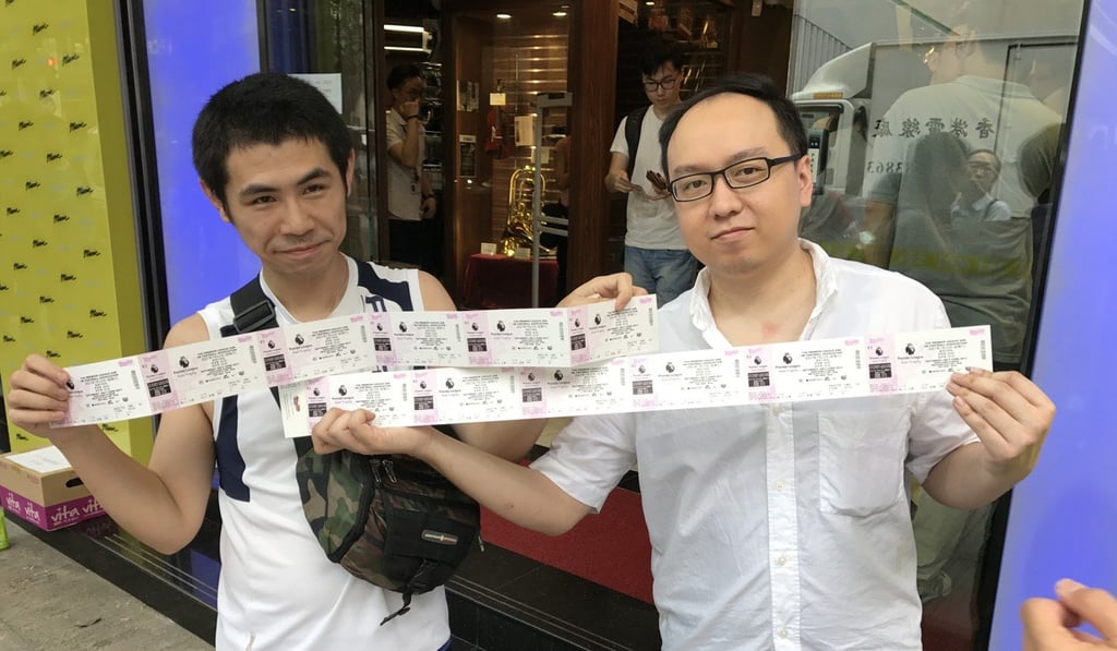 Mr Poon, a Liverpool fan, and friend with their tickets. Photo: Chan Kin-wa