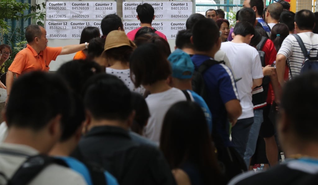 Parents queue up anxiously as they wait to receive results of their children’s school allocation. Photo: Edward Wong