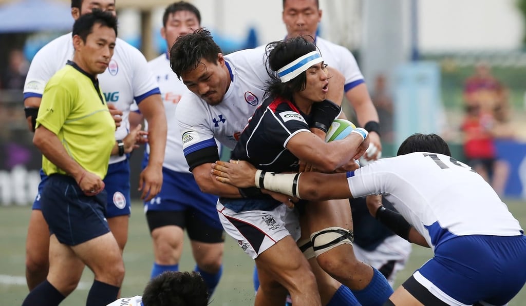 Hong Kong scrum half Cado Lee is swamped by his South Korea opponents. Photo: Jonathan Wong