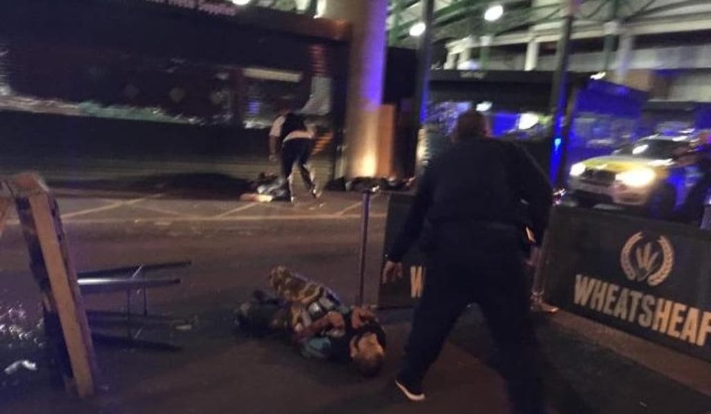 One picture from the Borough Market area showed a man lying on the ground. He appears to have canisters strapped to him, though it was unclear if he was an attacker or bystander. Photo: Gabrielle Sciotto