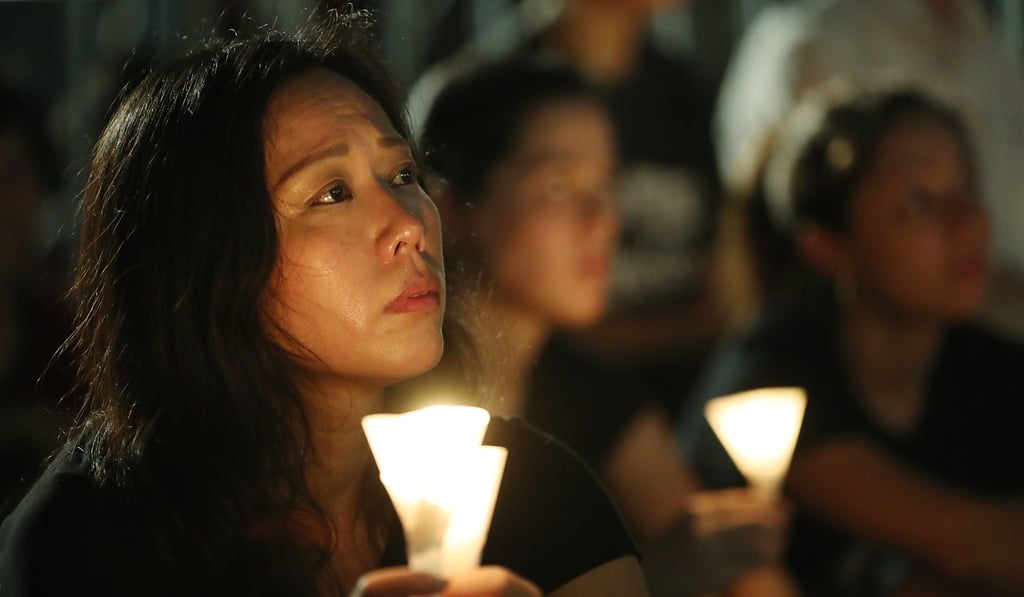 People holding candles at this year’s vigil at Victoria Park. Photo: Edward Wong
