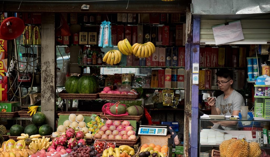 A fruit vendor minds his shop in Shenzhen on May 10. Food in mainland China is often fresher, being closer to the same sources that Hong Kong gets its produce from. Photo: AFP