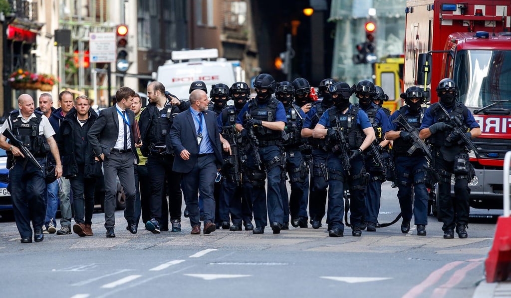 Armed police officers patrol streets near the scene of the previous night’s terror attack in London, on June 4. Photo: Bloomberg